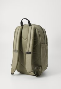 Olive green backpack with padded, contoured straps, a top handle, and a side pocket; features textured fabric and a smooth zipper.