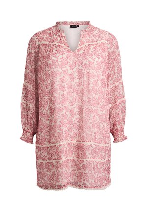 Tunika med blommönster i ljusrosa med mörkare rosa mönster, med V-ringning och rynkade ärmar, tillverkad av lättviktigt tyg.