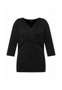 Musta paita, jossa on kolme neljännesosaa hihat ja V-pääntie. Edessä on käännösyksityiskohta, ja se on valmistettu sileästä, hieman joustavasta kankaasta.