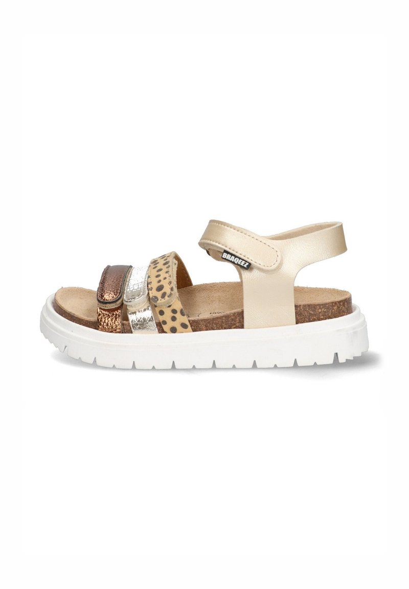 Beige sandals featuring three straps: one metallic brown, one shiny silver, and one with a leopard print. White rubber sole for traction.