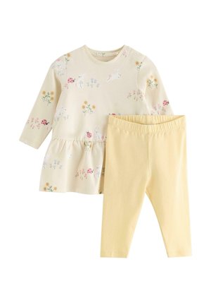 Pitkähihaiseen kermanväriseen mekkoon on painettu pupuja, leppäkerttuja ja kukkia, ja se on yhdistetty yksivärisiin keltaisiin, elastiseen vyötäröön joustaviin legginsseihin.