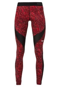 Legginsy w czerwony wzór z czarnymi akcentami i siateczkową teksturą. Posiadają szeroki pas z logo "NIKE", zaprojektowane do odzieży sportowej.