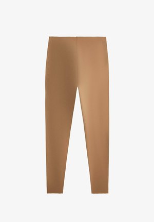 Rekbare beige slim-fit legging met een gladde textuur zonder zichtbare sluitingen of patronen, plat weergegeven op een witte achtergrond.