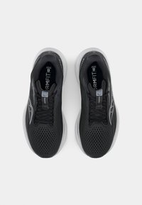 Black athletic shoes with a mesh upper, featuring a textured design, gray accents, and a light-colored sole. Laces and logo visible.
