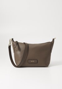 Borsa a tracolla in pelle marrone con superficie testurizzata, hardware dorato e chiusura superiore a zip. Presenta una tracolla regolabile e un'etichetta con logo.