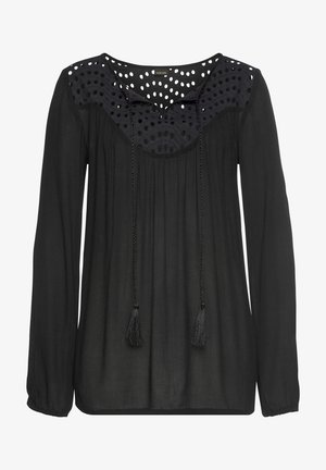 Schwarze Bluse aus leichtem Stoff; verfügt über lange Ärmel, ein gepunktetes Design auf dem Passe und Quasten an einem geflochtenen Kordelzug am Ausschnitt.