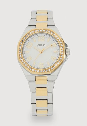 Stainless steel watch with octagonal face, gold accents, and crystal embellishments. White dial with gold hour markers and hands.