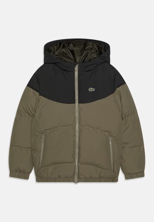 Olive green puffer jacket with a black upper section, zip closure, two side pockets, and elastic cuffs. Features a hood and brand logo.