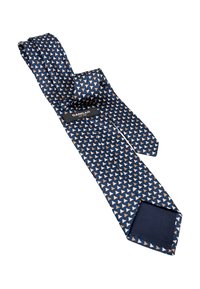 Tumedat sinise siidi lips valge ja beeži kolmnurgamustriga, volditud, et näidata brändi sildi "Sangar" ja vooderduse.