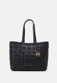 Sac fourre-tout en cuir tressé noir avec des poignées doubles, des accents en hardware doré et un charme de logo rond, présentant une surface texturée et une forme structurée.