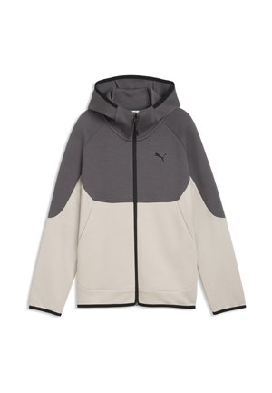 Chaqueta con capucha y cremallera completa, parte superior y mangas en gris oscuro, parte inferior en beige claro, bolsillos delanteros y logo de Puma en el pecho.