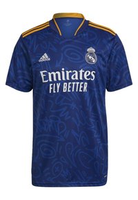 Blue short-sleeve jersey with a graphic pattern, featuring Adidas logo, "Emirates Fly Better" text, and Real Madrid crest. Gold accents on collar.