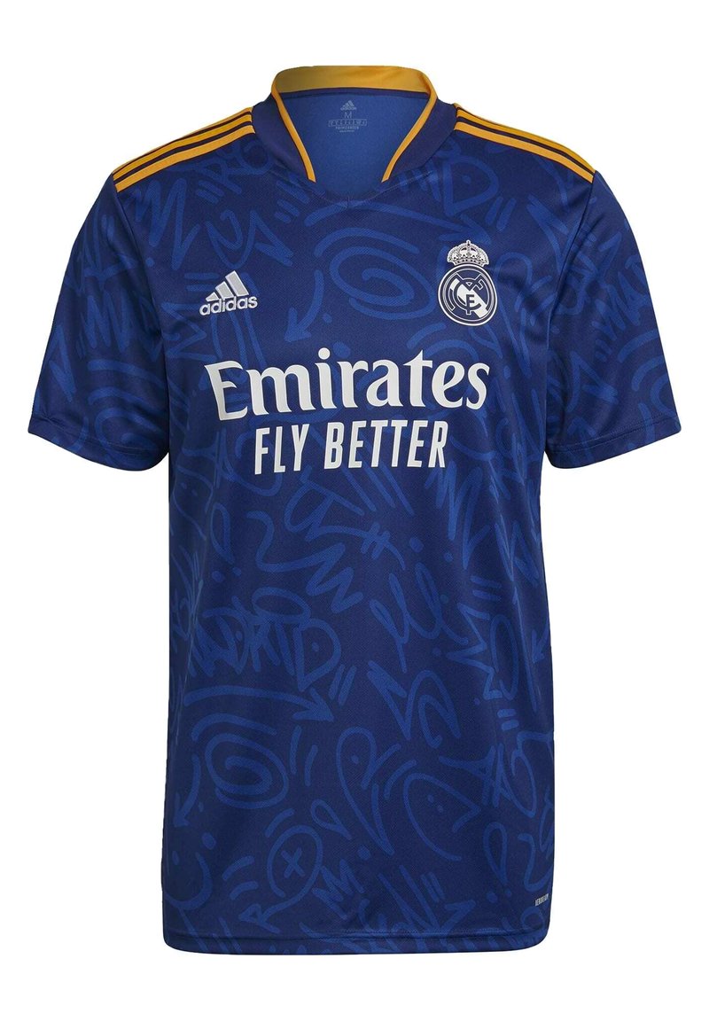 Blue short-sleeve jersey with a graphic pattern, featuring Adidas logo, "Emirates Fly Better" text, and Real Madrid crest. Gold accents on collar.
