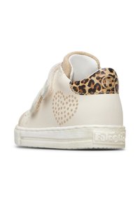 Sneakers en cuir blanc avec une sangle en paillettes dorées, des détails en forme de cœur sur le côté, et des accents en imprimé léopard sur le talon. Semelle en caoutchouc.