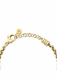 Bracciale in oro con anelli circolari, accenti a spirale e chiusura a gancio. Presenta un piccolo tag circolare con un dettaglio logo.