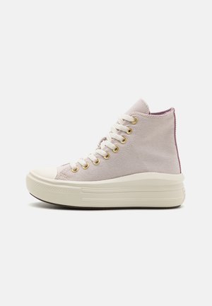 High-top sneakers in light purple canvas with gold eyelets, white laces, and a textured cream rubber sole with horizontal stripes.
