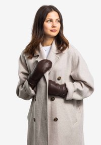 Hellegrauer, doppelt geöffneter Wollmantel, kombiniert mit dunkelbraunen Lederhandschuhen, die eine weiche Textur und große Knöpfe besitzen.