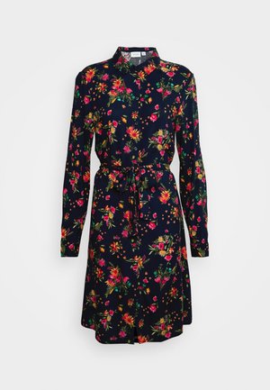 Laivastonsininen pitkähihaisten paitamekko monivärisellä kukkakuviolla, napillinen edessä, kaulus ja vyötäröllä samasta kankaasta tehty vyö.