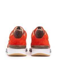 Sneakers in suede rosso con retro in pelle marrone, caratterizzati da una suola intermedia bianca e suola esterna grigia. Parte superiore testurizzata con dettaglio del logo sul tallone.