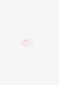 Light pink lipstick smear with smooth texture and subtle shimmer on a white background.