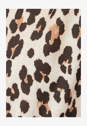 Tessuto con stampa leopardata caratterizzato da macchie irregolari marrone scuro e beige chiaro su uno sfondo avorio, con un aspetto morbido e testurizzato.