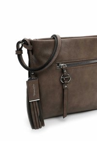 Brown faux leather crossbody bag with a zippered compartment, tassel accents, and a detachable strap. Features silver hardware.
