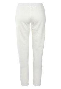 Weiße Trainingshose aus weichem Stoff, mit elastischem Bund, schmal zulaufenden Beinen und ohne sichtbare Taschen oder Verzierungen.