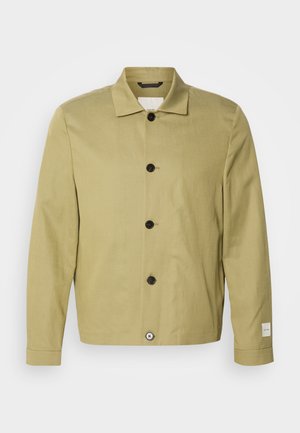 Light olive green jacket made of linen, featuring a straight cut, black buttons, and a tag on the sleeve. No patterns or embellishments visible.