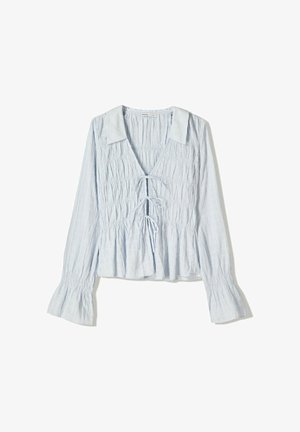 Hellblaue Bluse mit langen Ärmeln, geraffter Textur, V-Ausschnitt, Schnürdetail vorne und ausgestellten Ärmelbündchen. Baumwollstoff mit lässigem Design.