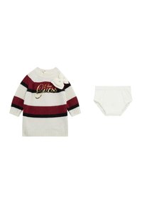 Abito maglione di colore crema con strisce rosse e nere, con la scritta "I love Guess" in oro. Include un copri-pannolino bianco coordinato.