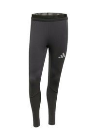 Schwarze Sportleggings mit einer figurbetonten Passform, ausgestattet mit einem breiten Bund und einem Logo-Akzent. Hergestellt aus einem glatten, elastischen Stoff.