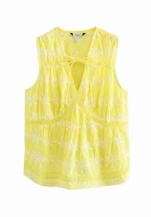 Blouse sans manches jaune avec broderie florale blanche, col en V avec fermeture par lien, et détails en dentelle sur le devant et l'ourlet.