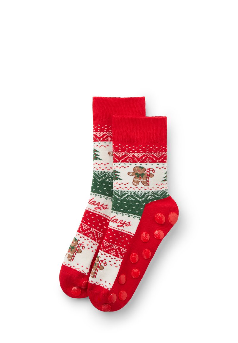 Rood-witte sokken met patronen van peperkoekmannetjes, zuurstokken en kerstbomen; rood met textuur voor antislipzolen.