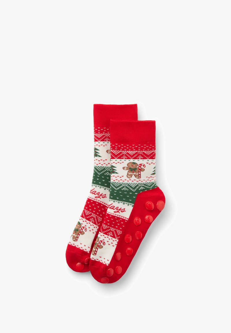Chaussettes à motifs rouges et blancs avec des bonshommes en pain d'épice, des cannes en sucre d'orge et des sapins de Noël ; semelles rouges texturées antidérapantes.