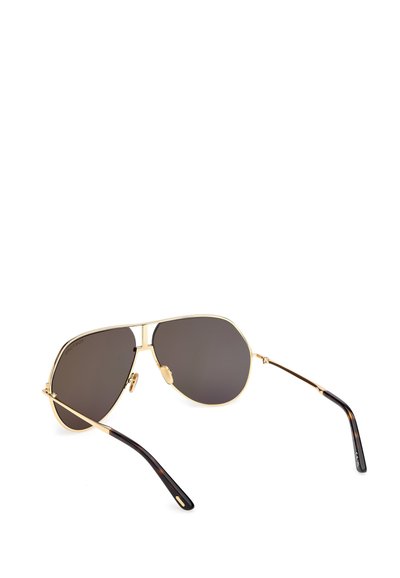 Pilotské sluneční brýle s tmavě šedými skly, zlatým kovovým rámem a černými želvovinovými stranami. Obsahují dvojitý mostní design a nastavitelné nosní podložky.