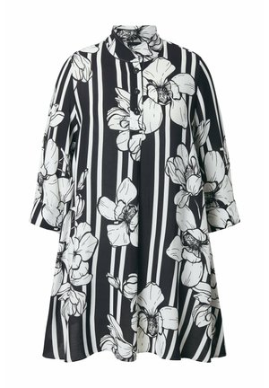 Schwarz-weißes langärmliges Tunika mit großem weißem Blumenmuster und vertikalen Streifen, mit Mandarin-Kragen und drei Knöpfen vorne.
