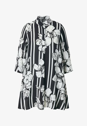 Zwart-witte tuniek met lange mouwen, grote witte bloemenprint en verticale strepen, voorzien van een mandarijnkraag en drie knopen aan de voorkant.