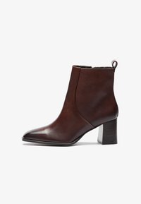 Brown leather ankle boot with a pointed toe and block heel. Features a seamless design and a loop at the back for easy wear.