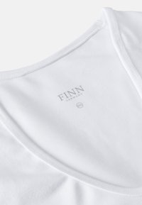 White cotton shirt with a round neckline, featuring a smooth texture. A label reads "FINN GERMANY" in gray, with size "XXL" indicated.