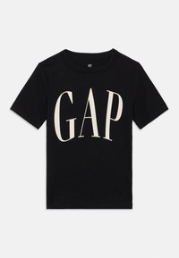 Μαύρο βαμβακερό t-shirt με μεγάλο, κρεμ λογότυπο GAP σε στιλιζαρισμένη γραμματοσειρά, κοντά μανίκια και κλασικό στρογγυλό λαιμό.
