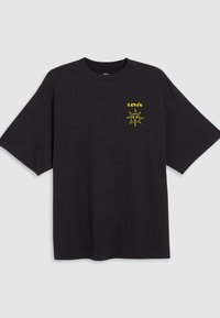 Black t-shirt made of cotton with short sleeves, featuring a yellow sun graphic and the text "LEVI'S" in bold above the design.