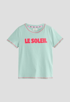 Light blue cotton t-shirt with short sleeves, pink accent stitching, and bold "LE SOLEIL" text in pink across the front.