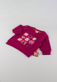 Felpa fucsia caratterizzata da grafiche di animali giocose, scollo rotondo e bottoni a scatto sulla spalla. Include un'etichetta a forma di orso.