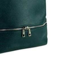 Teal leren tas met een gestructureerd oppervlak, een ritsvak met dubbele zilveren trekhendels en een platte bodem voor stabiliteit.