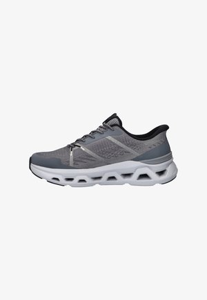 Gray lace-up athletic shoe with mesh upper, cushioned sole featuring geometric cutouts, and black interior lining.