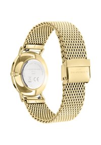 Uhr aus goldfarbenem Edelstahl mit geflochtenem Mesh-Armband und rundem Gehäuse. Auf der Rückseite der Uhr sind eingravierte Markeninformationen zu sehen.