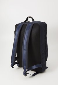 Navy backpack with mesh back, padded straps, and a structured shape. Features durable material and sleek design, suitable for daily use.