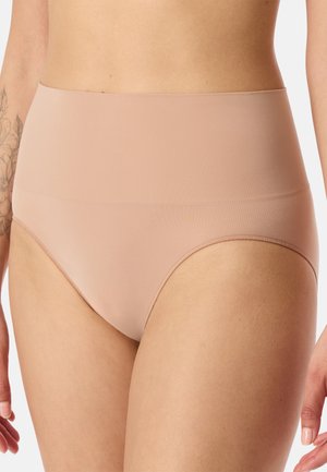 Woman wearing beige high-waisted seamless underwear, showing torso and upper thighs with tattoo visible on left arm.