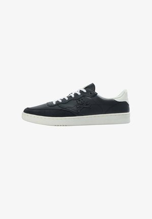Sneakers neri in pelle con punta in suede, lacci bianchi e logo con teschio e ossa incrociate sul lato. Suola in gomma bianca, profilo slanciato.
