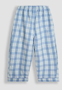 Helehall ja valge ruuduline pehme riie, pajama püksid, elastse vöökoht, sirged sääred ja volditud varrukad lihtsal taustal.